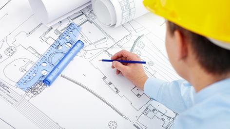 Engineer reviewing lift planning and diagnosis drawings