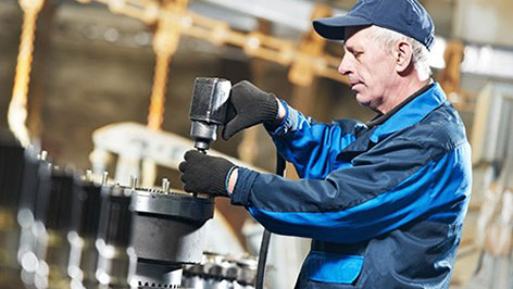 Technician repairing and testing mechanical lift components